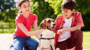 children petting a beagle